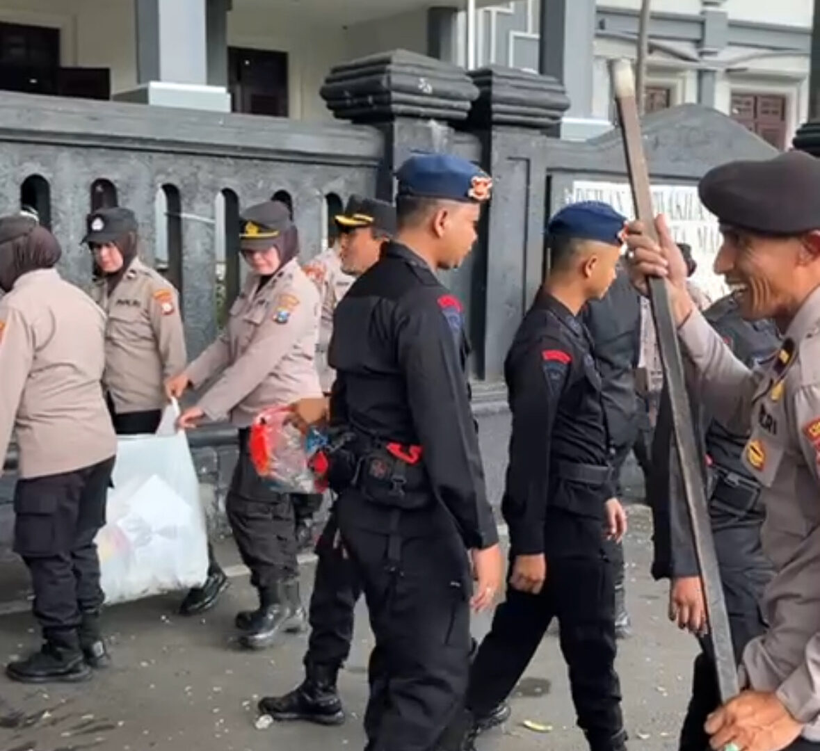 “Polisi Dan TNI Membersihkan Sampah Usai Demo Hari Buruh Di Depan Gedung DPRD Kota Malang